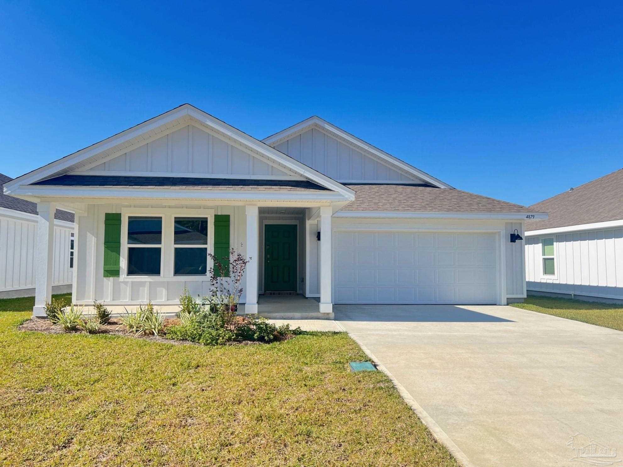 a front view of a house with yard outdoor seating and garage