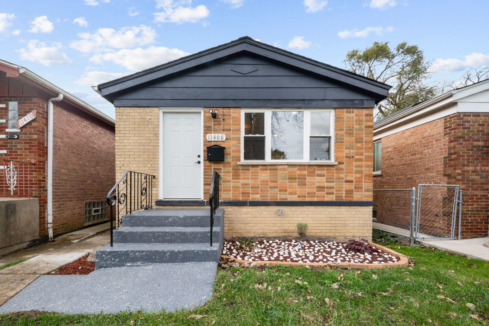 a view of front door of a house with a yard