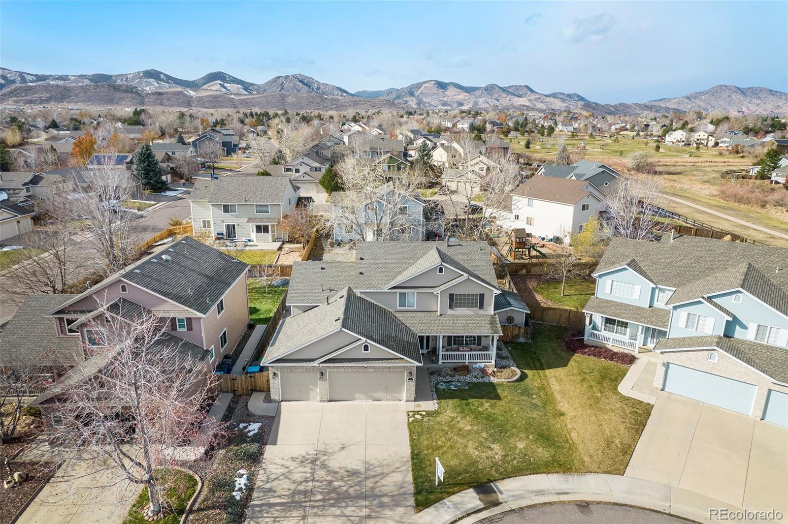 an aerial view of a house with a mountain