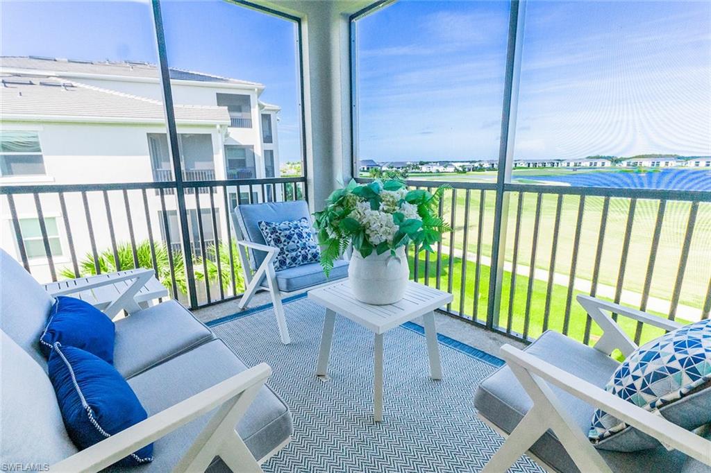 a view of a chairs and table in the balcony