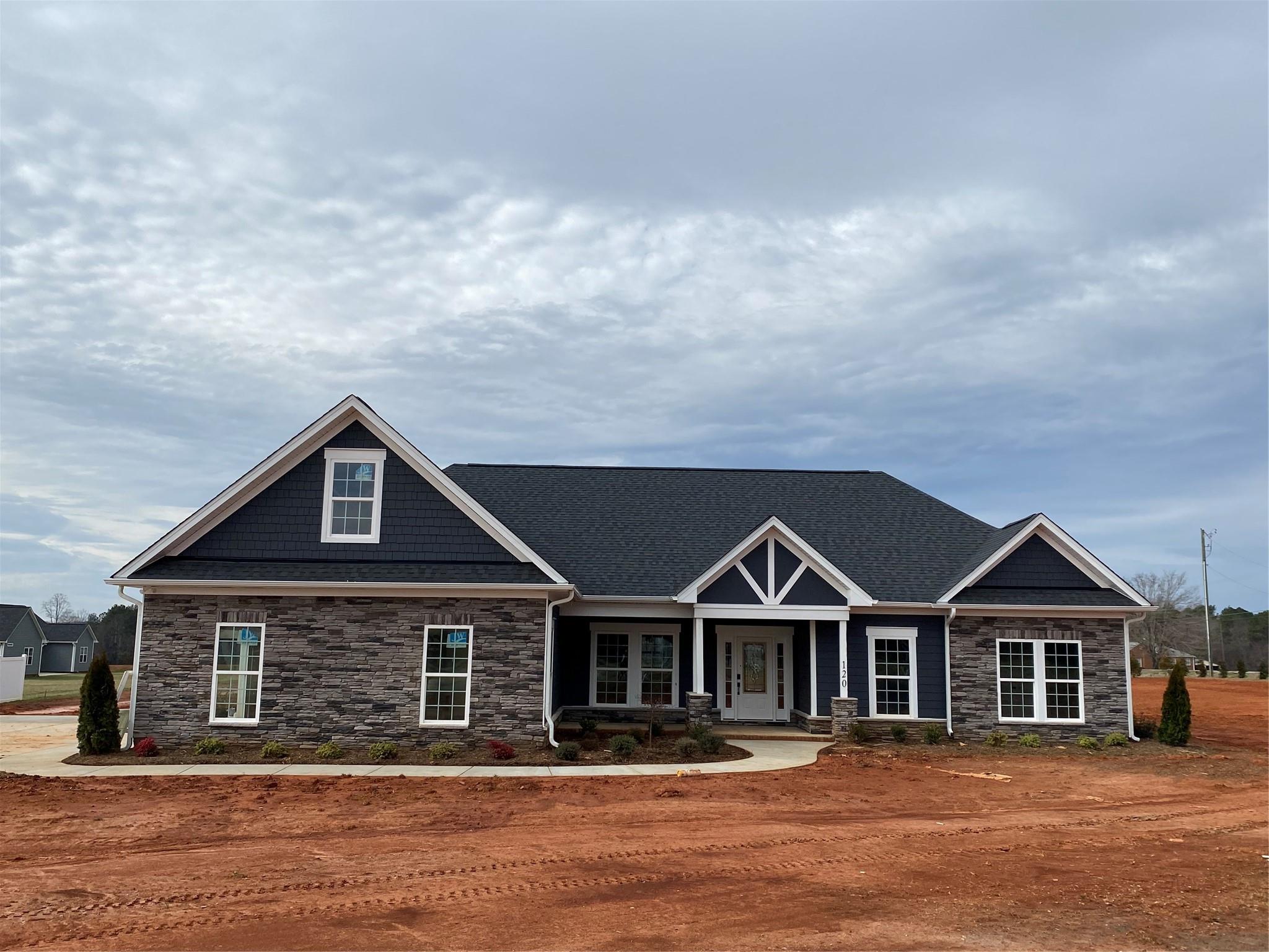 a front view of a house with a yard