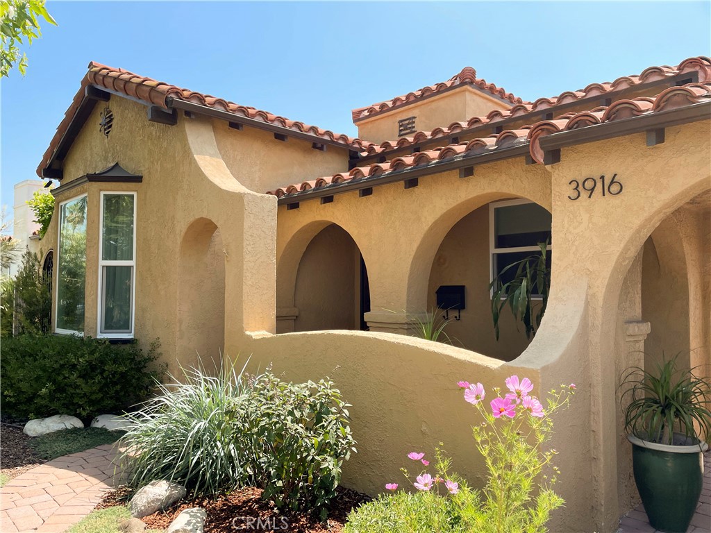 a front view of a house with plants