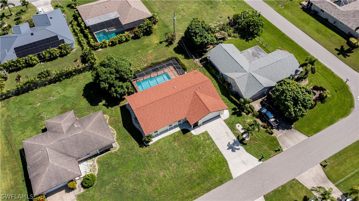 an aerial view of a house with garden space and street view