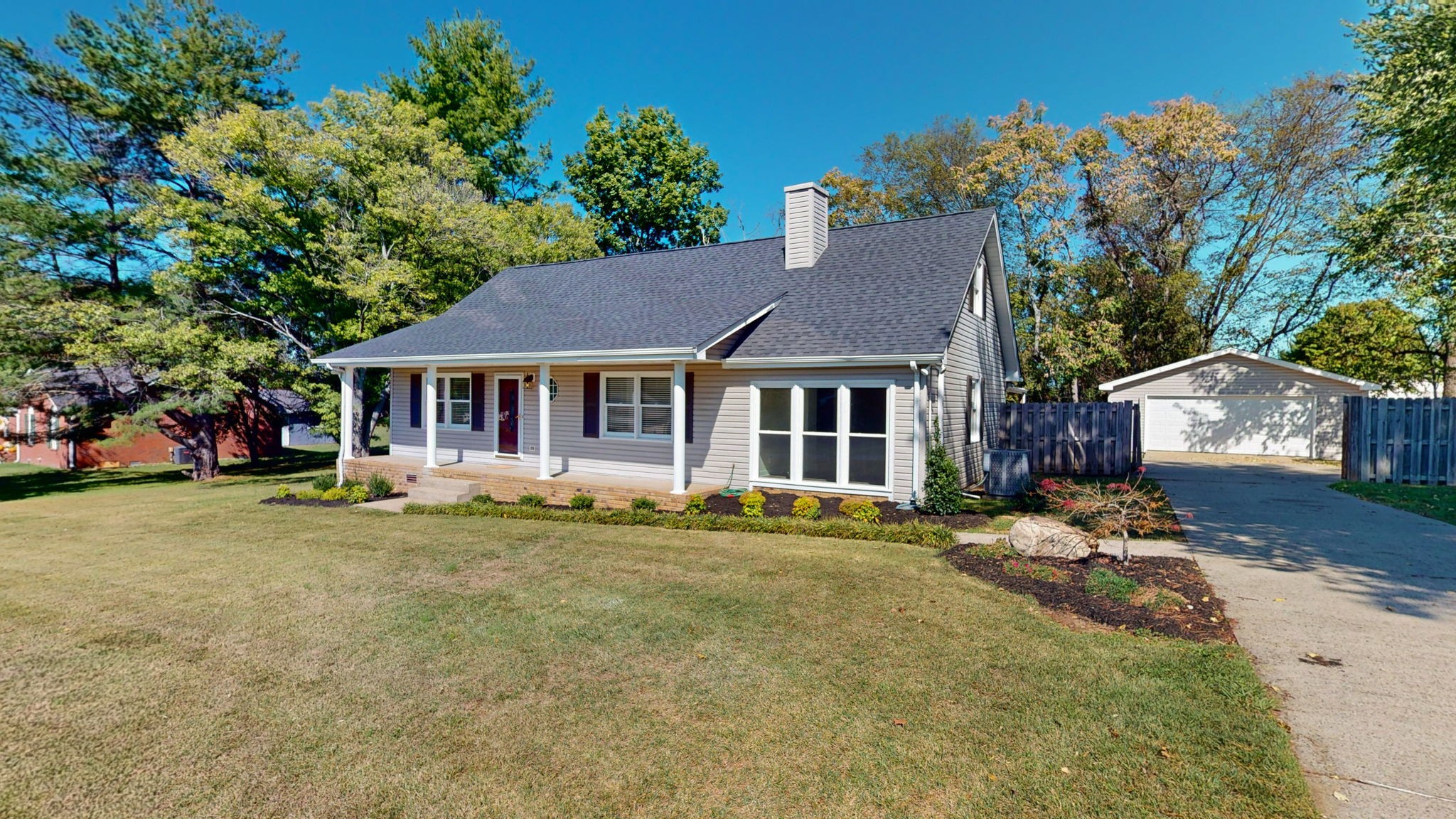 a front view of a house with a garden