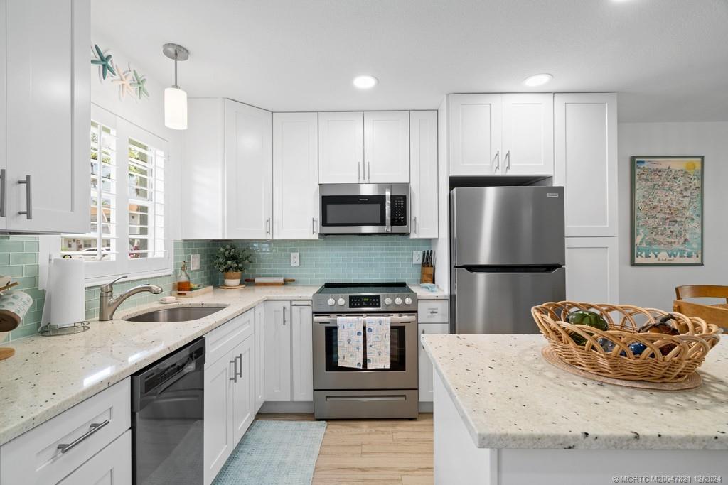 a kitchen with a sink a stove and refrigerator