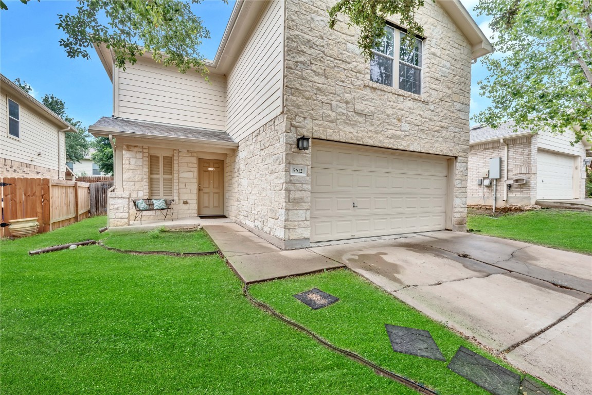 a front view of a house with a garden and plants