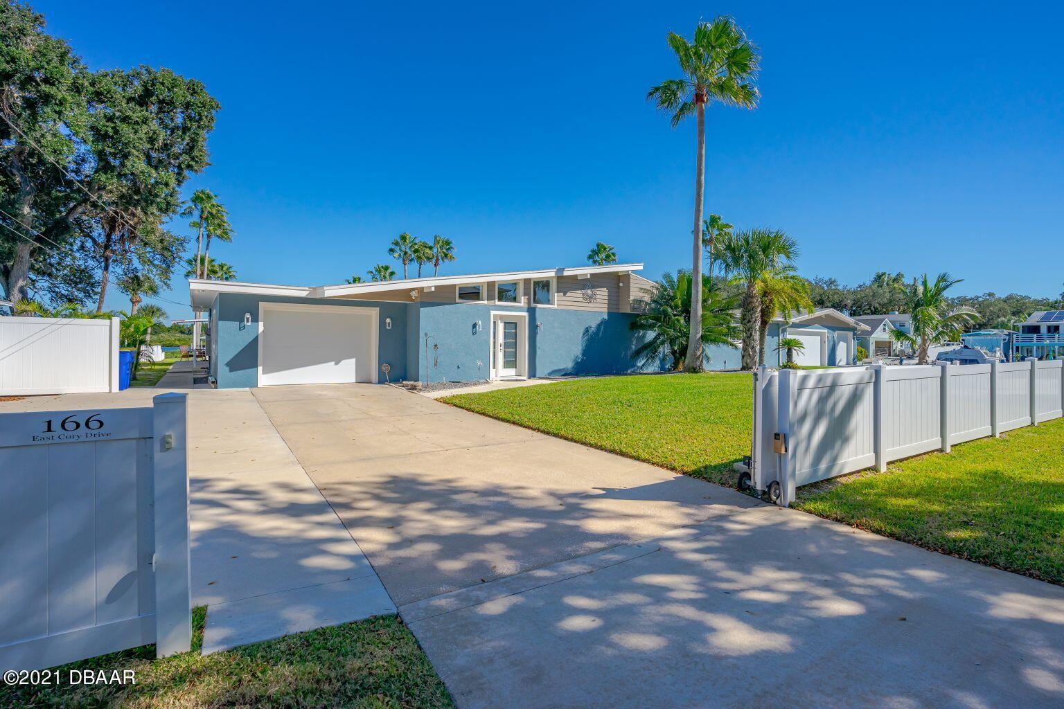 a view of a house with palm trees