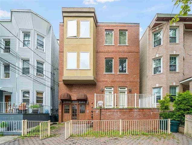 a front view of a house with a fence