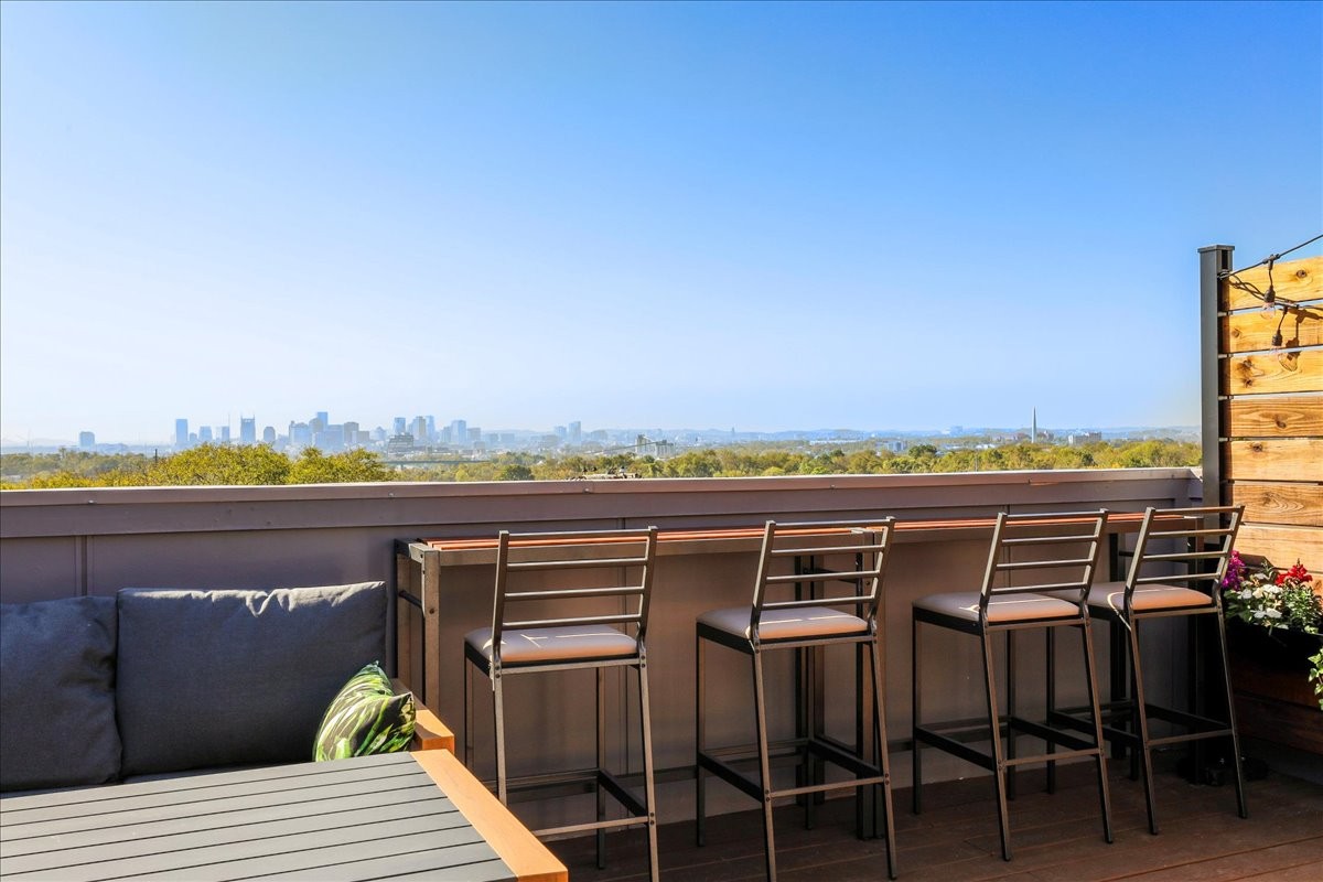 a view of a roof deck with lounge chair