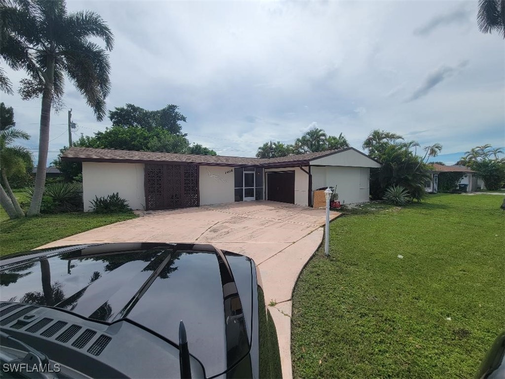 a front view of house with a garden