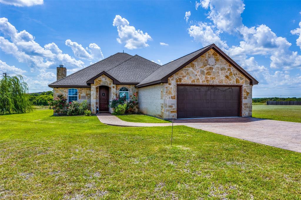 a view of a house with a yard and garage