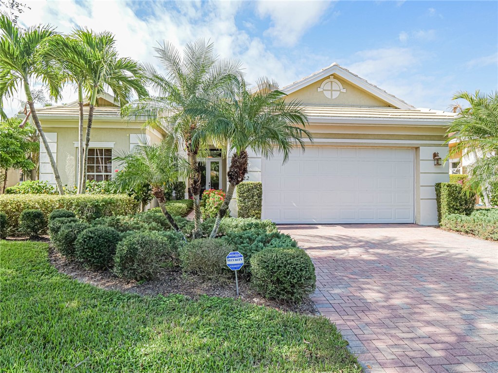 a front view of a house with a yard and a garage