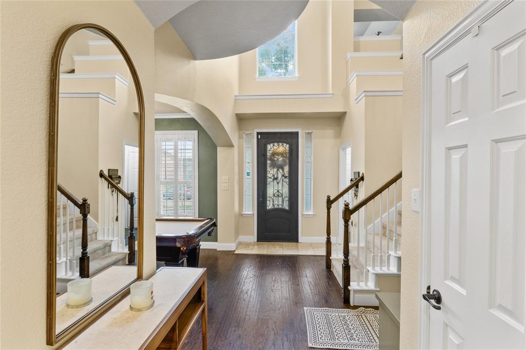 a view of an entryway with wooden floor and door