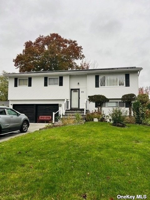 a view of a house with a patio and a yard