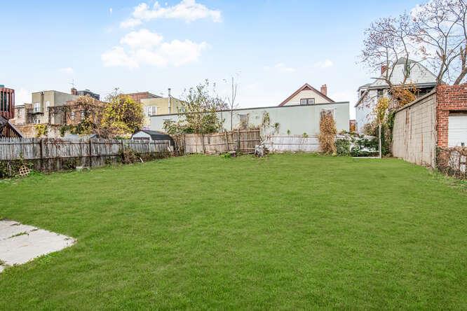 a view of a house with a yard and sitting area