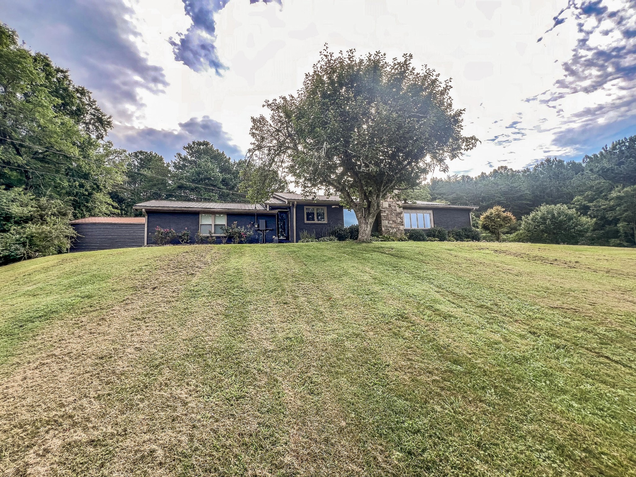 a view of a house with a yard and sitting area