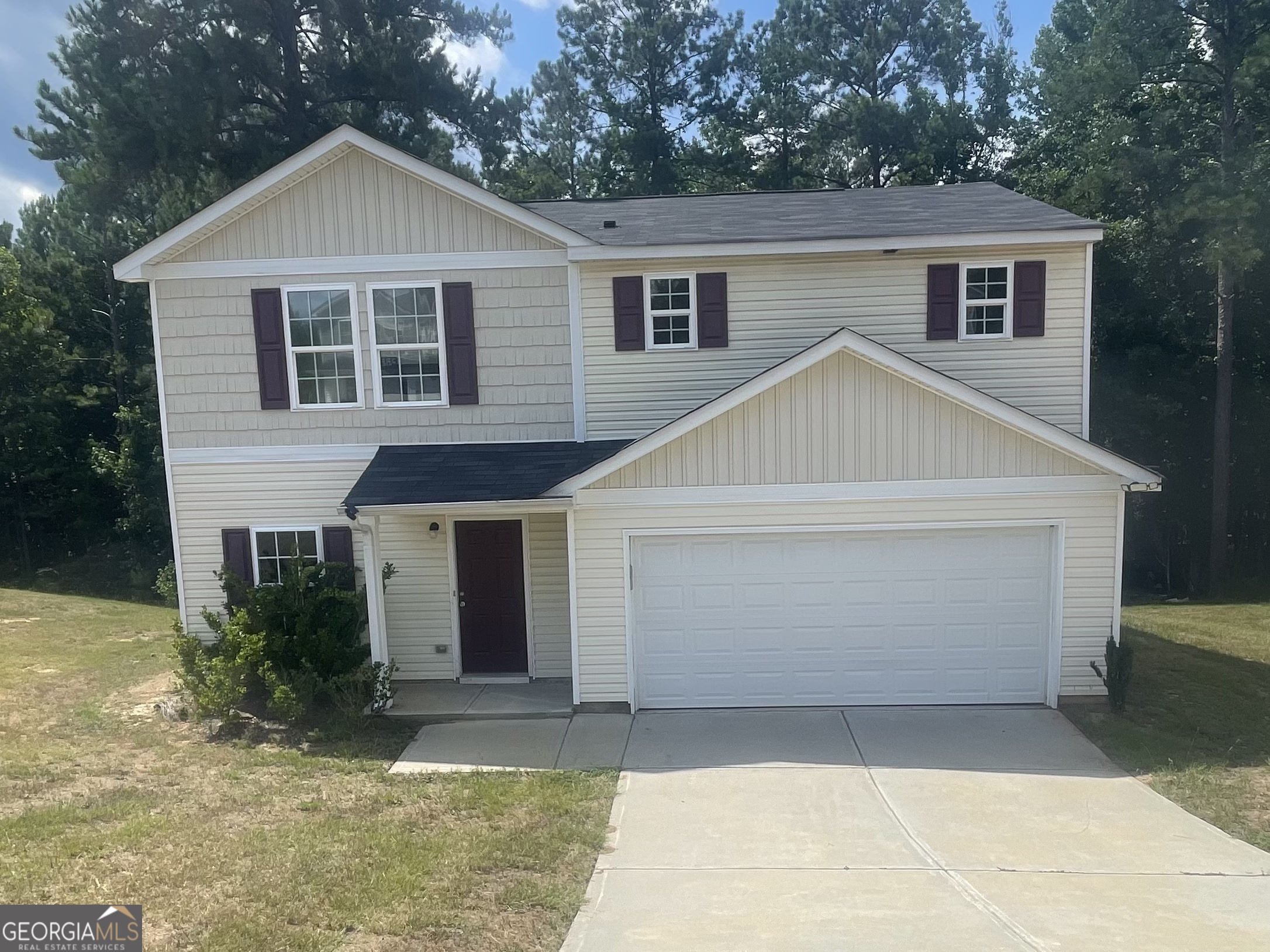 a front view of a house with a yard and garage