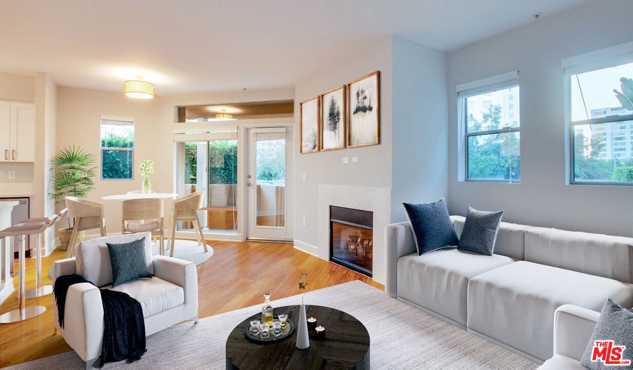 a living room with furniture a fireplace and large windows