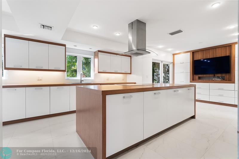 a kitchen with stainless steel appliances a microwave a stove and white cabinets