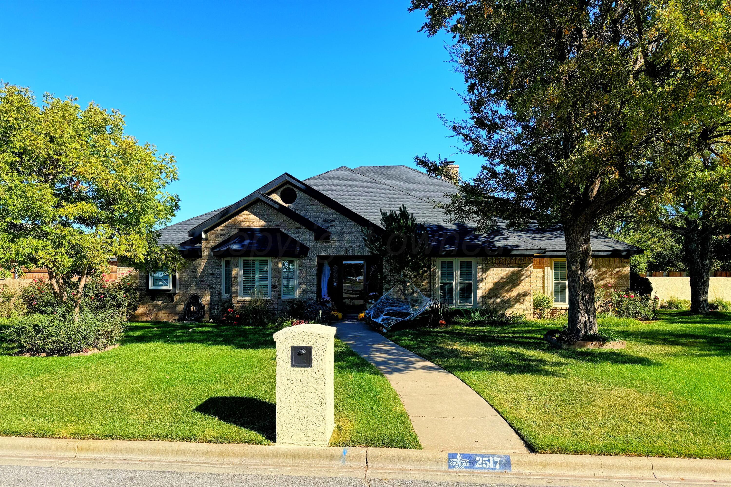 a front view of house with yard and green space