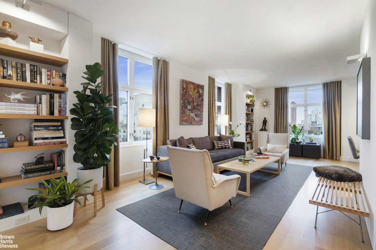 a living room with furniture and a potted plant