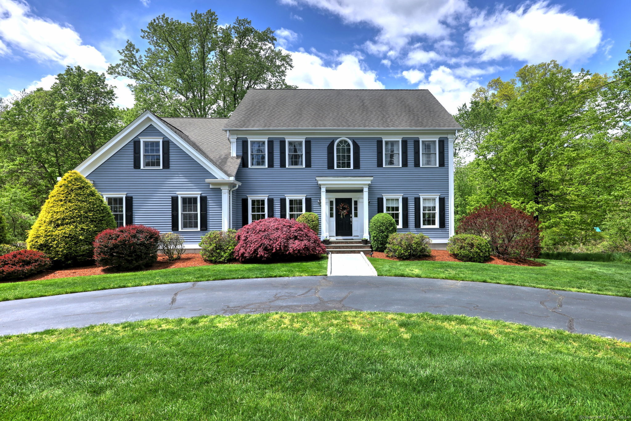 a front view of a house with a yard and porch