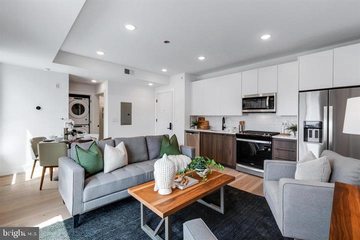 a living room with furniture kitchen and a view of kitchen