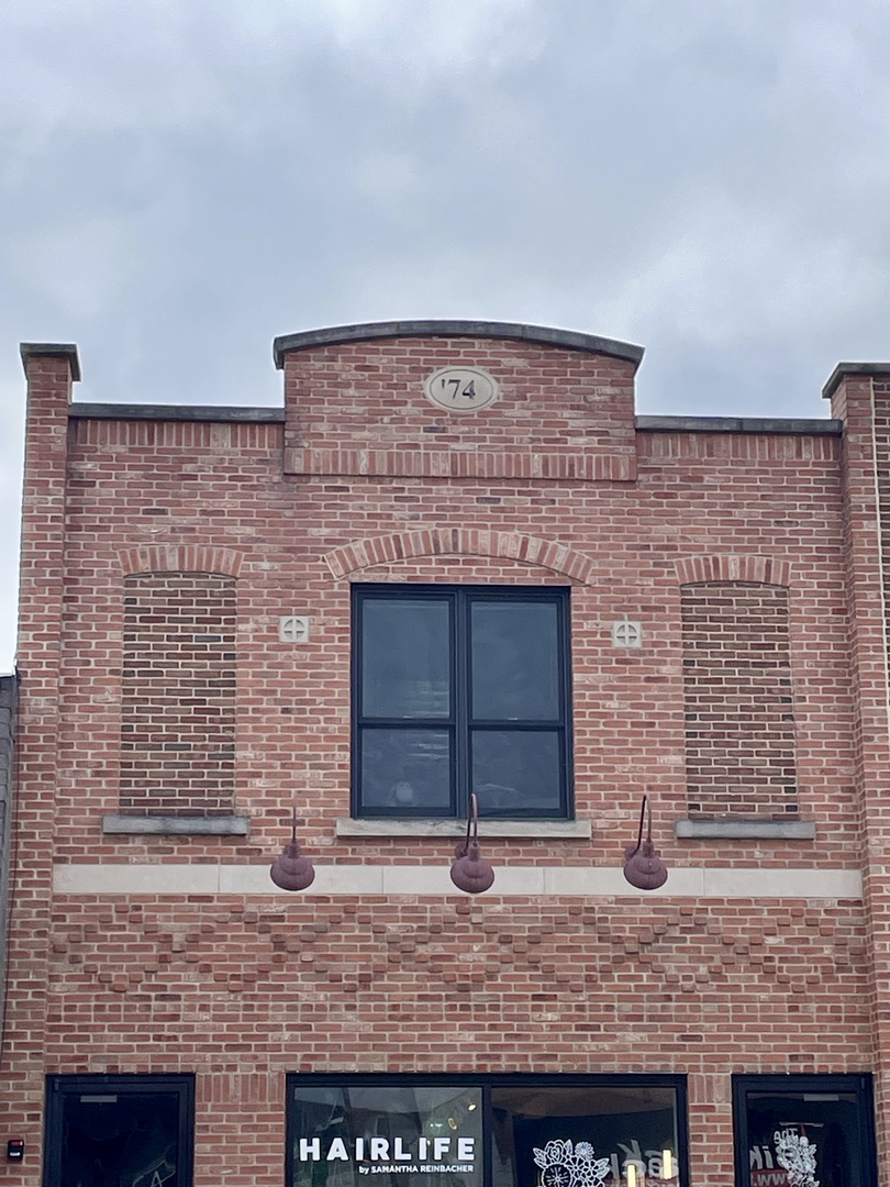 a brick house with a door and large windows