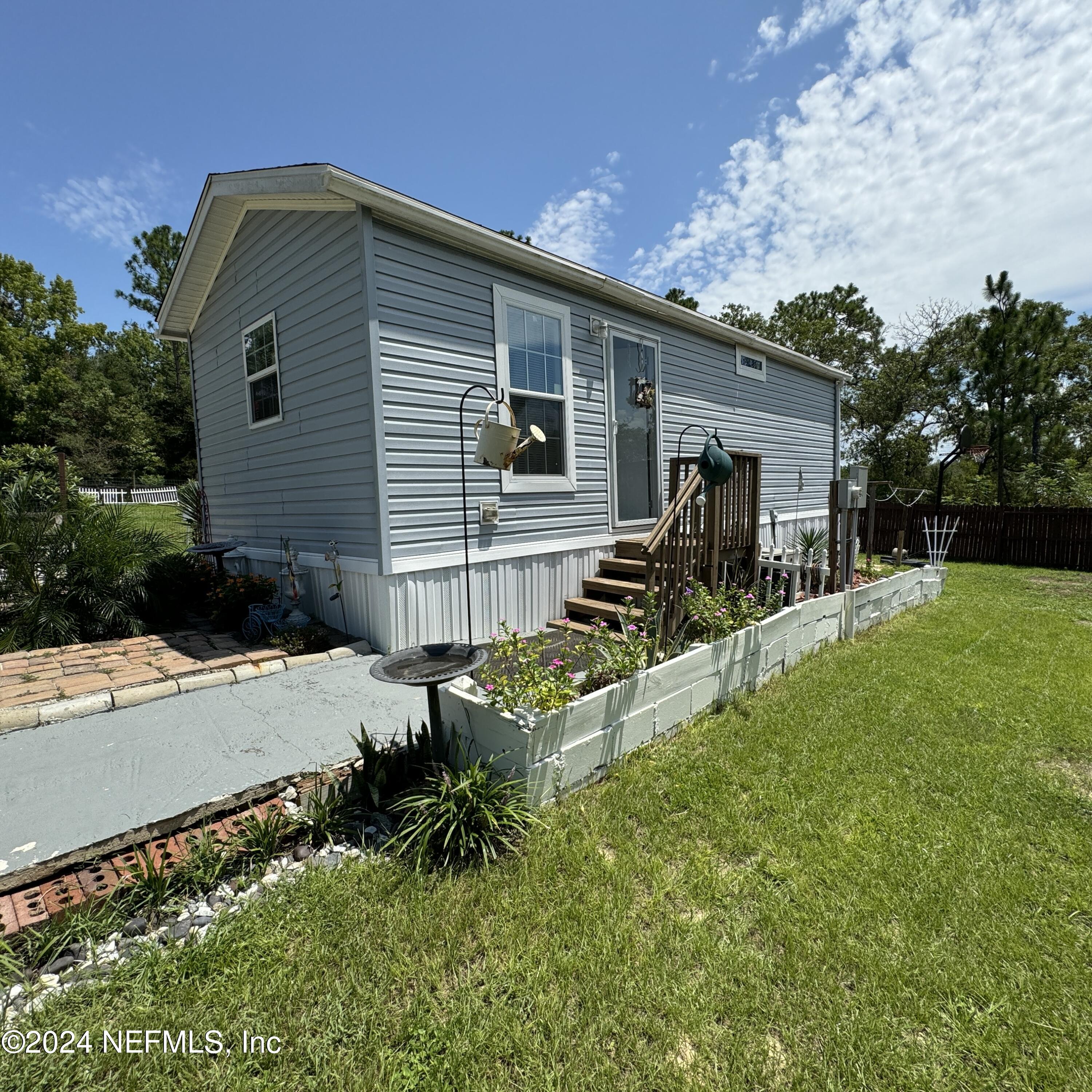 a front view of house with yard and outdoor seating