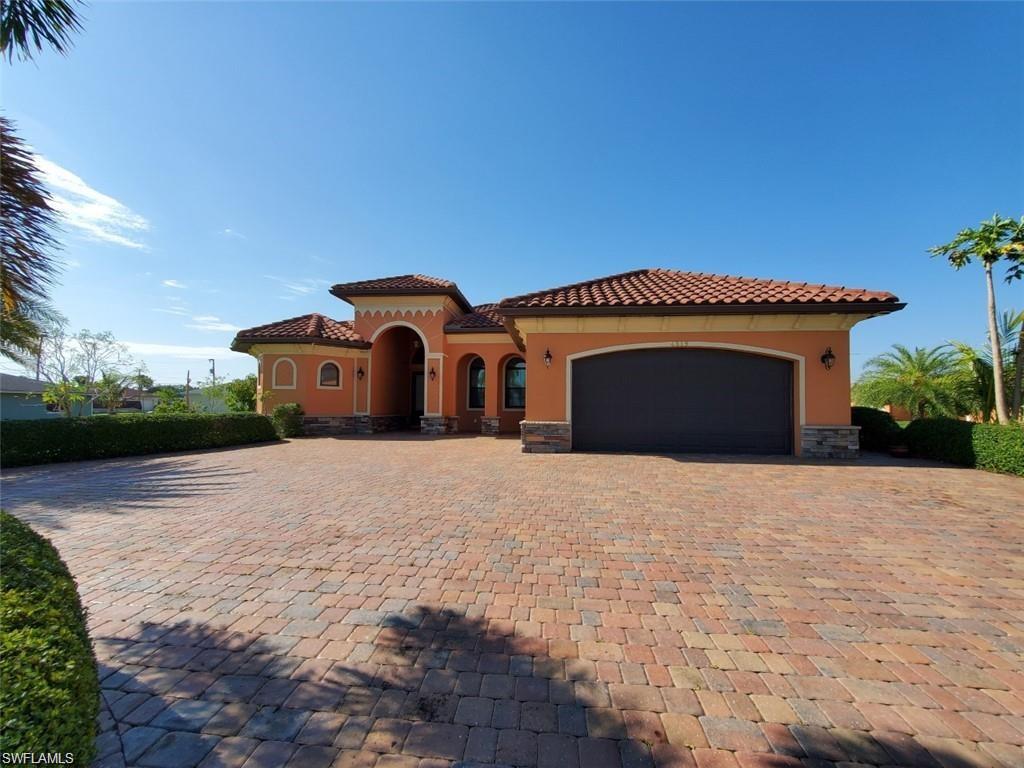 Mediterranean / spanish home featuring a garage