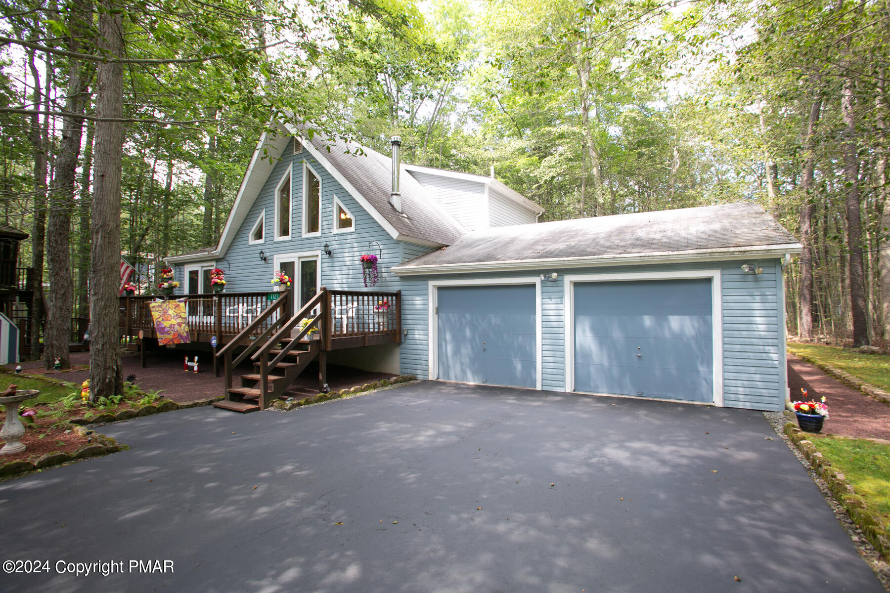 a view of a house with a patio and a car parked