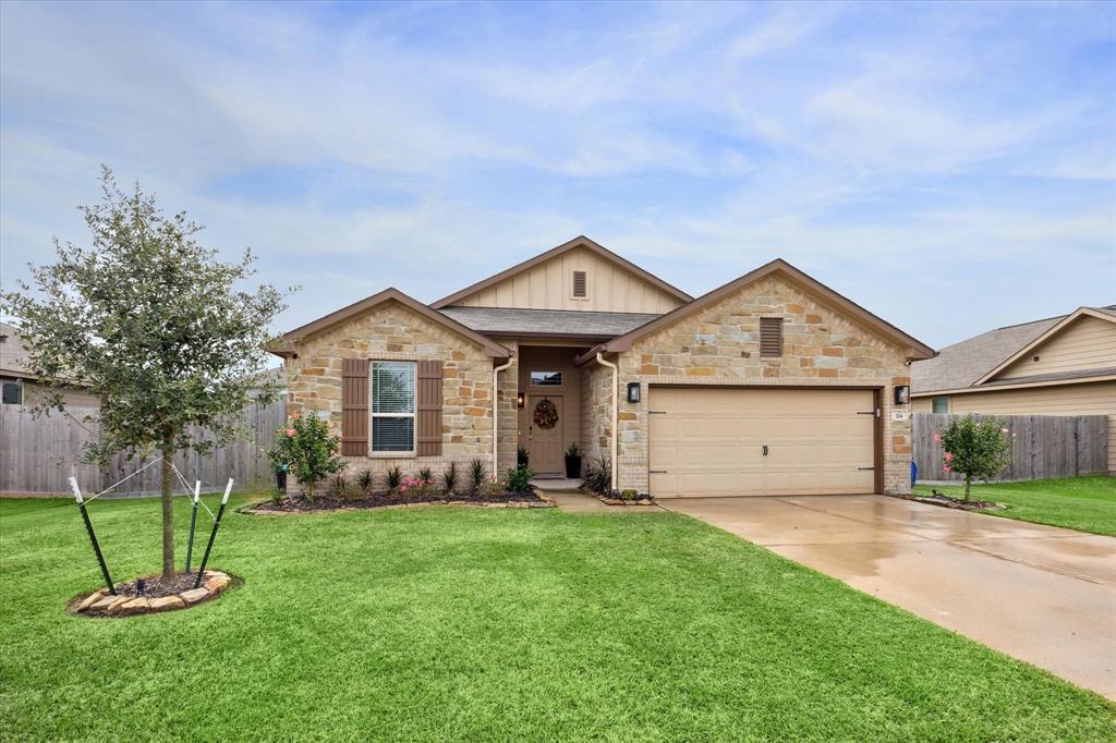 a front view of a house with a yard and fence