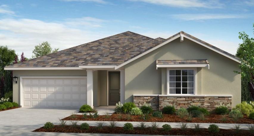 a front view of a house with garage and plants