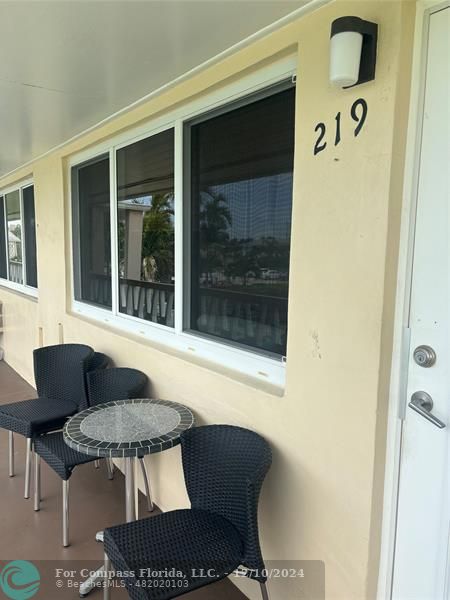 a balcony with table and chairs