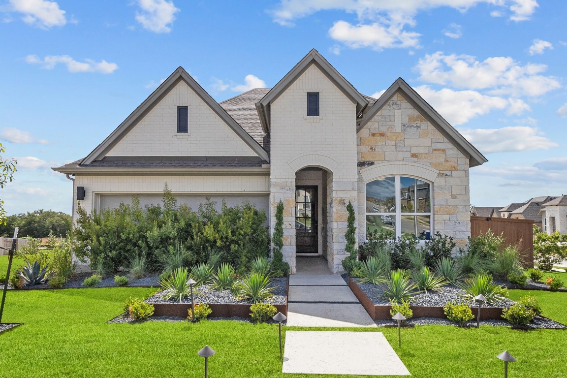 a front view of a house with a yard