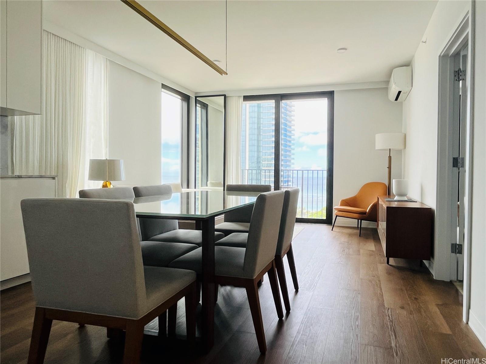 a view of a dining room with furniture and wooden floor