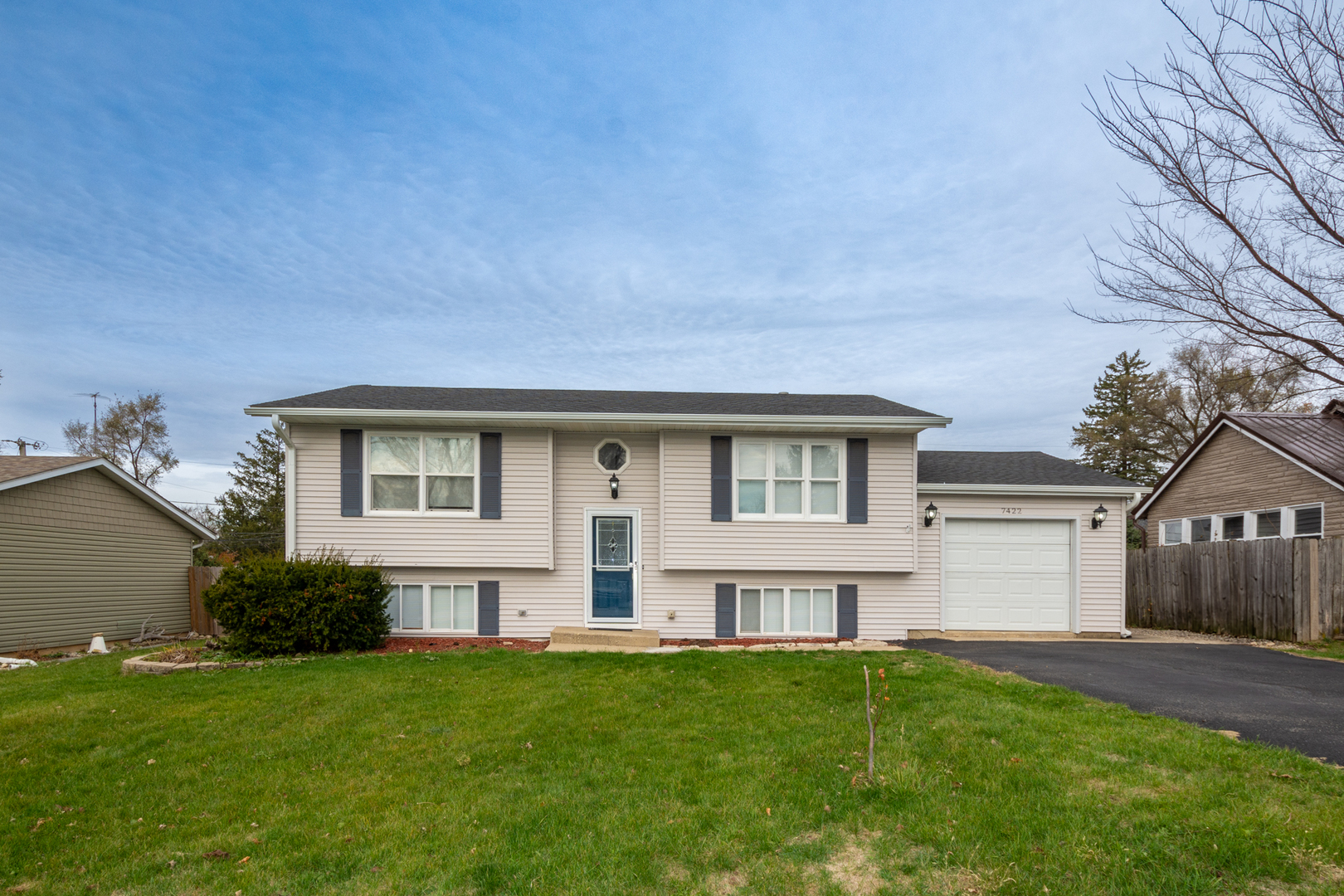 a front view of house with yard and green space