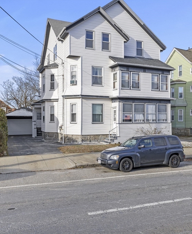 a car parked in front of a big house