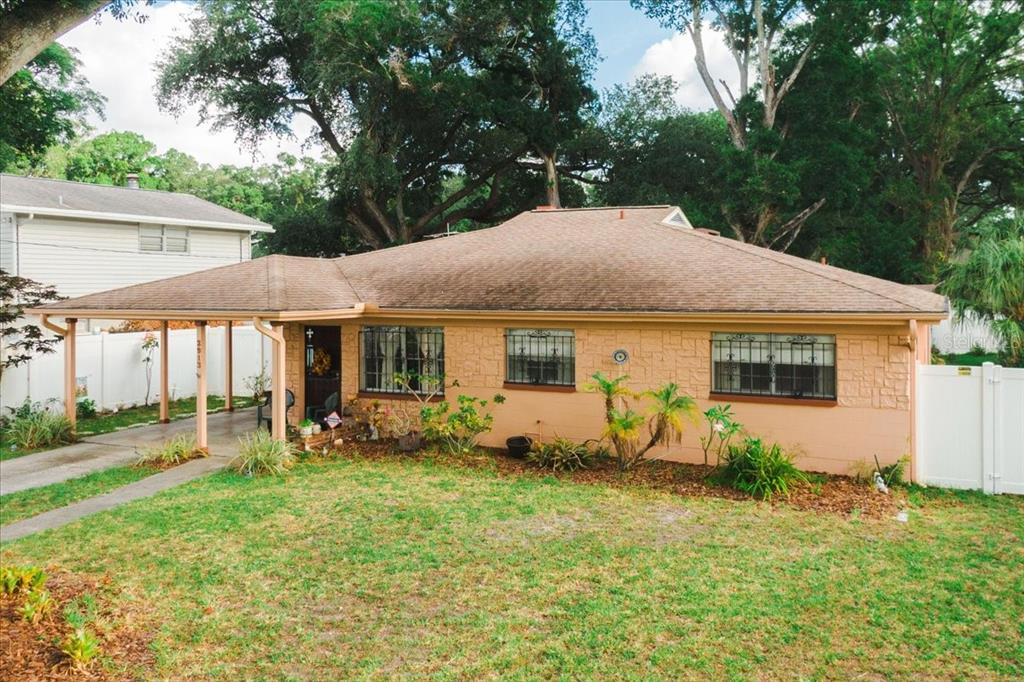 a view of a house with backyard sitting area and garden