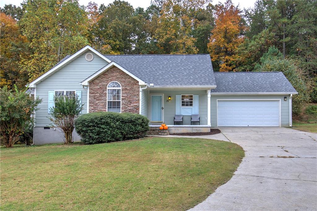 a view of a house with a yard and large tree