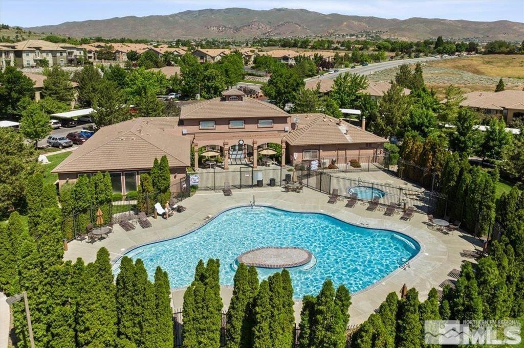 a view of a house with pool and a yard