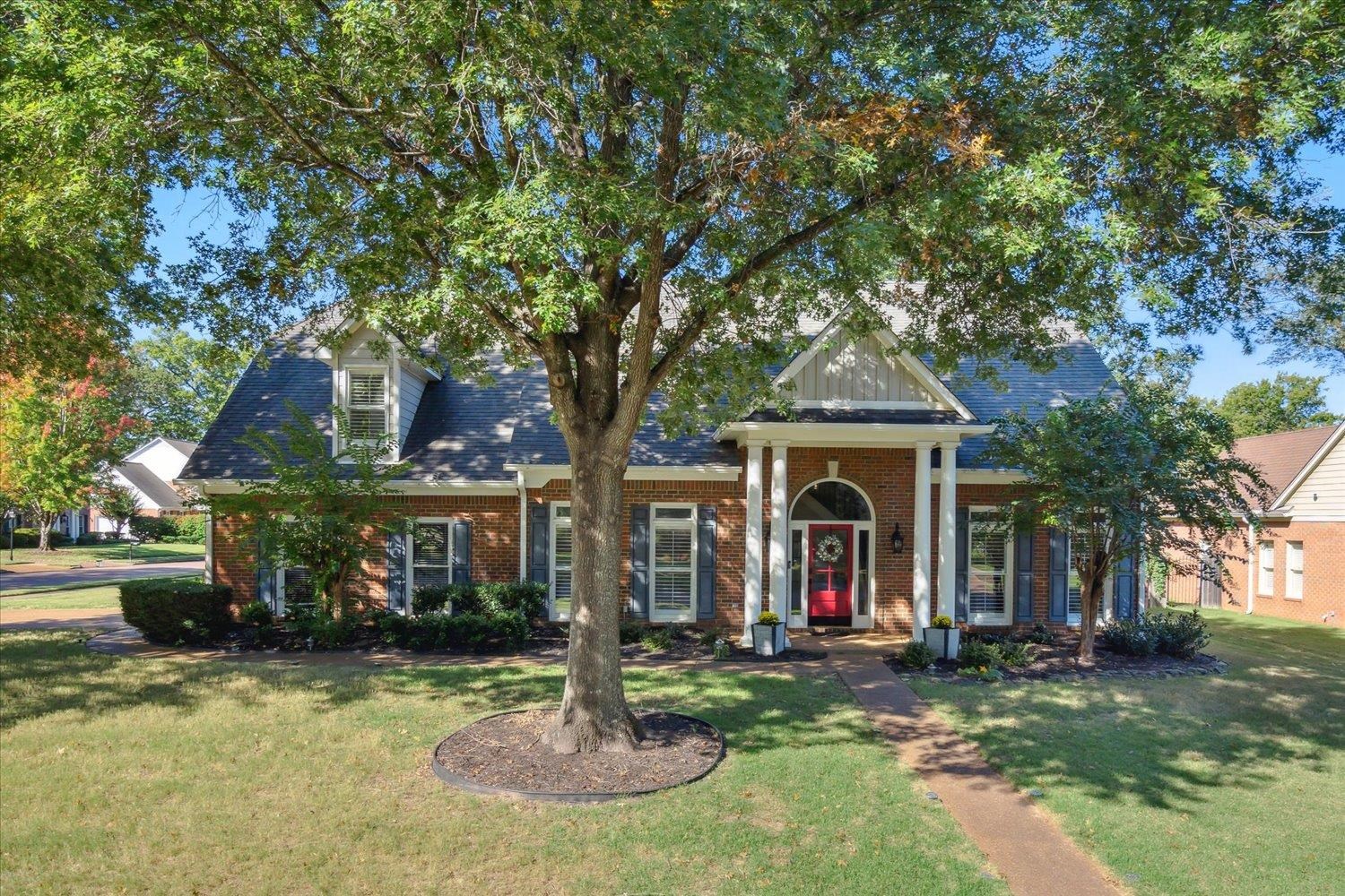 a front view of a house with yard swimming pool and outdoor seating