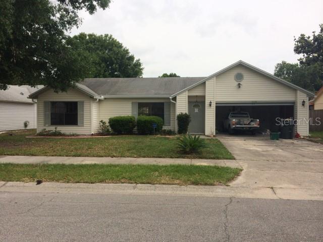 a front view of a house with a garden and garage