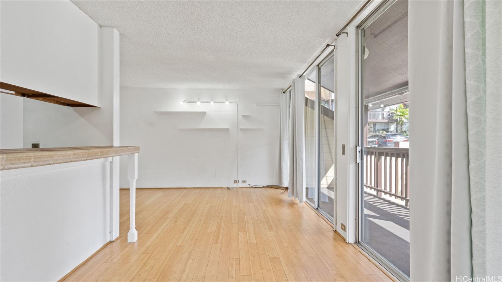 a view of a hallway with wooden floor and entryway