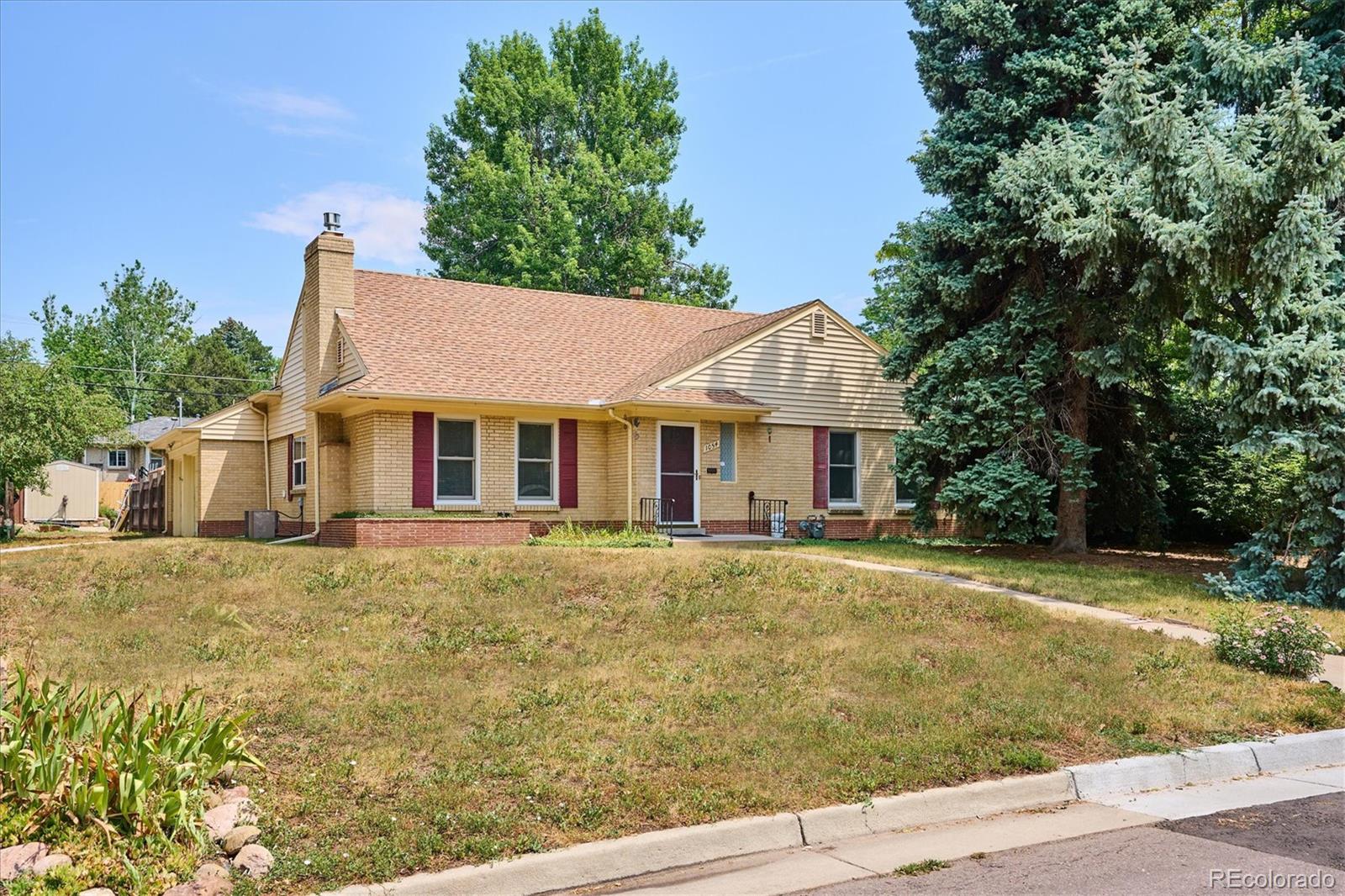 a front view of a house with a garden and porch