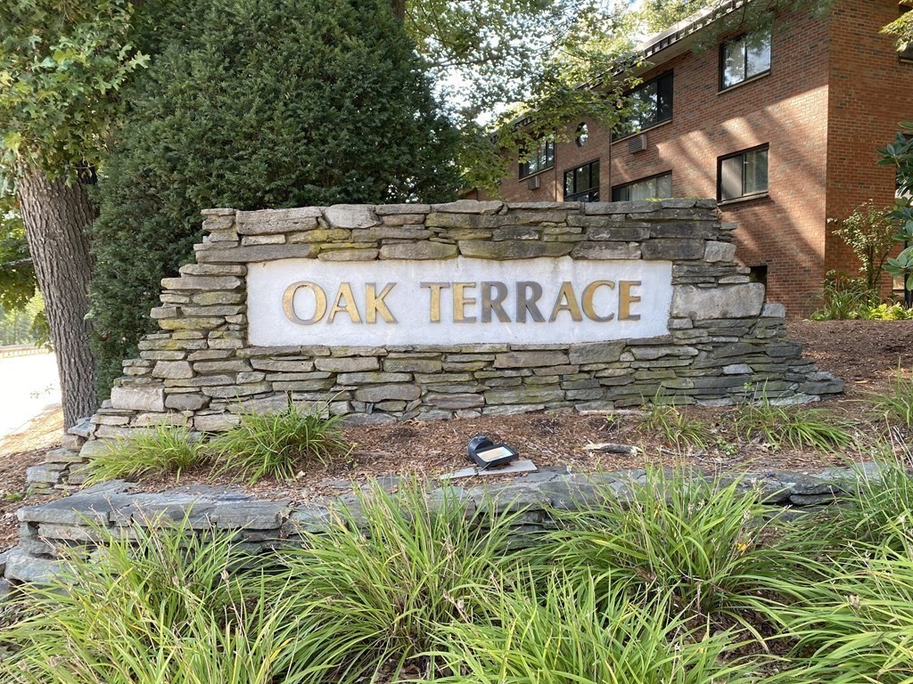 a sign that is sitting in front of flowers