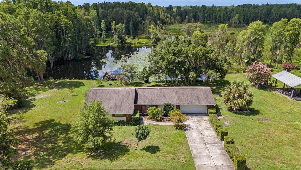 an aerial view of a house with a yard