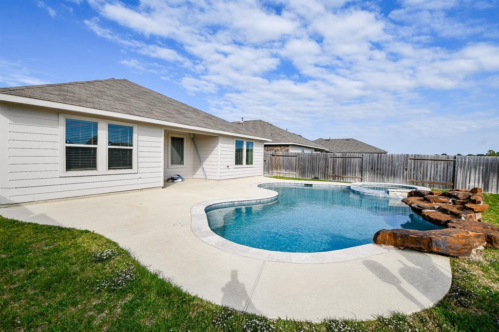 a view of a house with swimming pool and sitting area