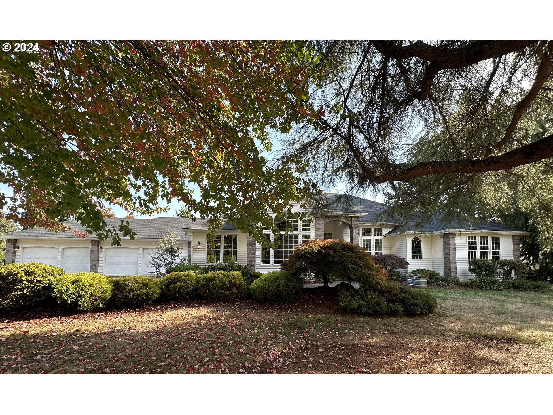 a front view of a house with a garden