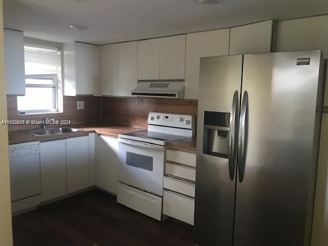 a kitchen with cabinets and stainless steel appliances